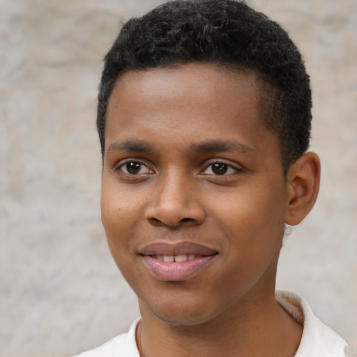 Joyful black young-adult male with short  brown hair and brown eyes