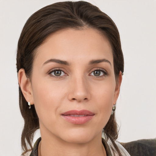 Joyful white young-adult female with medium  brown hair and grey eyes