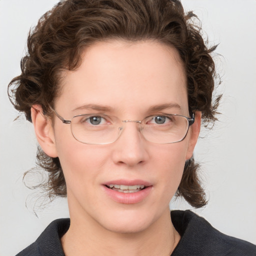 Joyful white adult female with medium  brown hair and grey eyes