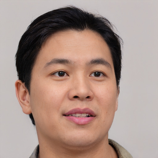 Joyful asian young-adult male with short  brown hair and brown eyes