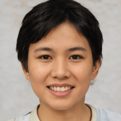 Joyful asian young-adult female with short  black hair and brown eyes