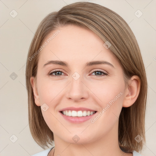 Joyful white young-adult female with medium  brown hair and green eyes