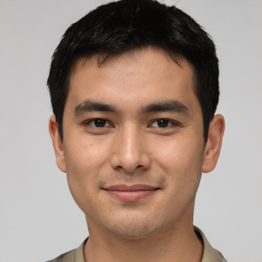 Joyful asian young-adult male with short  black hair and brown eyes