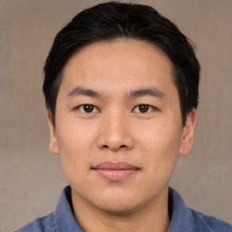 Joyful asian young-adult male with short  brown hair and brown eyes