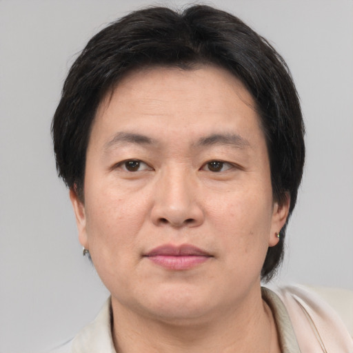 Neutral asian adult male with short  brown hair and brown eyes