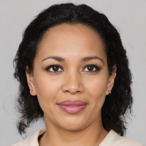 Joyful latino young-adult female with medium  black hair and brown eyes