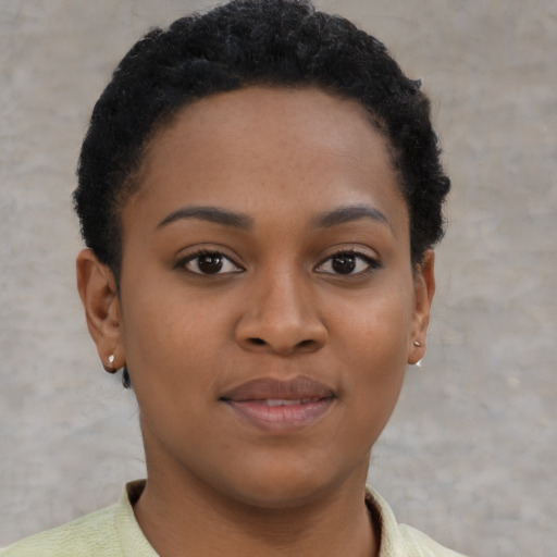 Joyful black young-adult female with short  brown hair and brown eyes