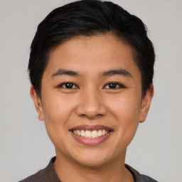 Joyful asian young-adult male with short  black hair and brown eyes