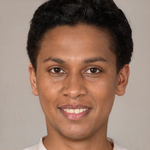 Joyful latino young-adult male with short  brown hair and brown eyes
