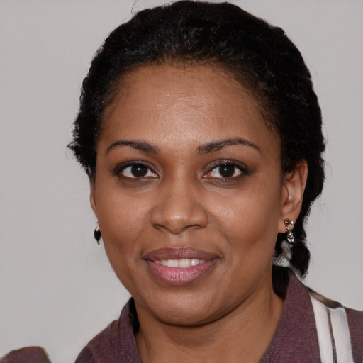 Joyful black young-adult female with medium  black hair and brown eyes