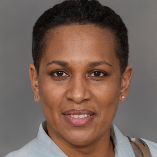Joyful latino adult female with short  brown hair and brown eyes