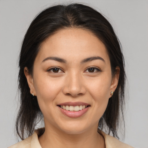 Joyful asian young-adult female with medium  brown hair and brown eyes