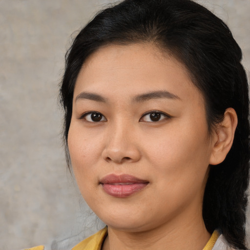 Joyful asian young-adult female with medium  brown hair and brown eyes