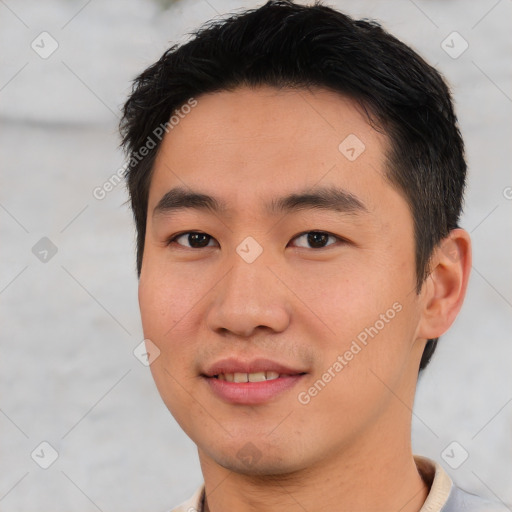 Joyful asian young-adult male with short  black hair and brown eyes