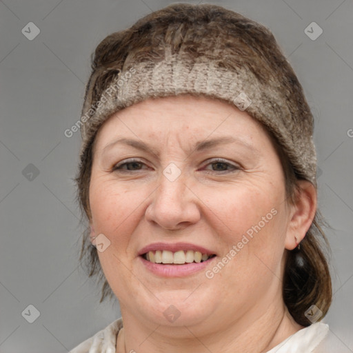 Joyful white adult female with medium  brown hair and blue eyes