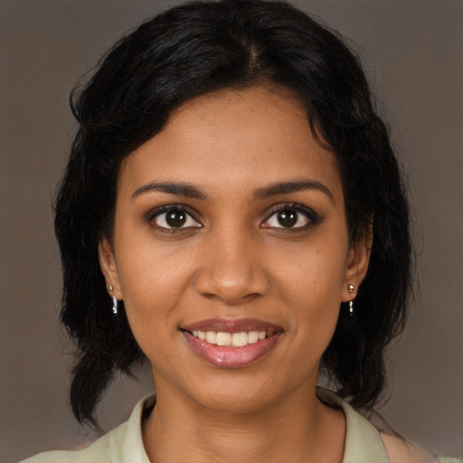 Joyful black young-adult female with medium  brown hair and brown eyes