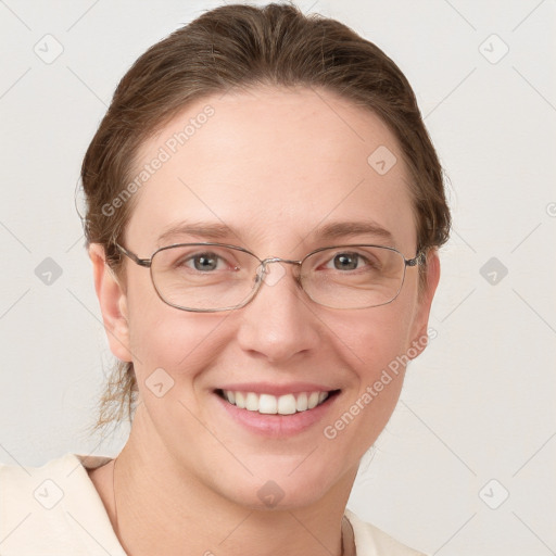 Joyful white adult female with medium  brown hair and grey eyes