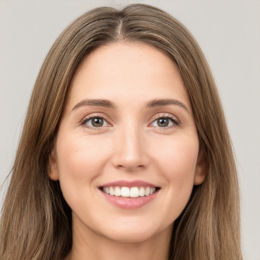 Joyful white young-adult female with long  brown hair and green eyes