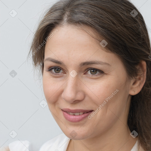 Joyful white adult female with medium  brown hair and brown eyes