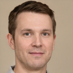 Joyful white adult male with short  brown hair and grey eyes