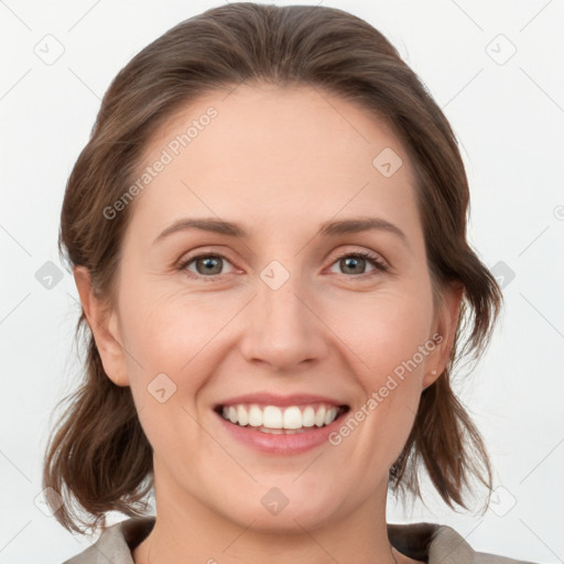 Joyful white young-adult female with medium  brown hair and grey eyes