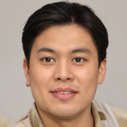 Joyful asian young-adult male with short  brown hair and brown eyes