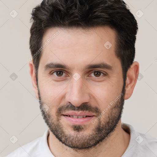 Joyful white young-adult male with short  black hair and brown eyes