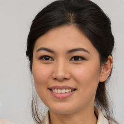 Joyful asian young-adult female with medium  brown hair and brown eyes