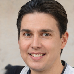 Joyful white adult male with short  brown hair and brown eyes