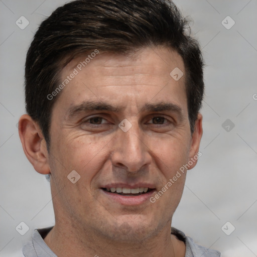 Joyful white adult male with short  brown hair and brown eyes