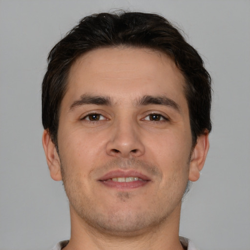 Joyful white young-adult male with short  brown hair and brown eyes