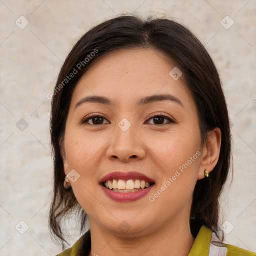 Joyful latino young-adult female with medium  brown hair and brown eyes