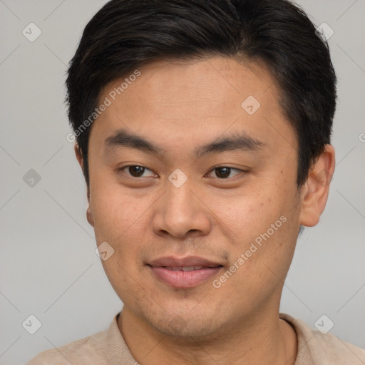 Joyful asian young-adult male with short  brown hair and brown eyes