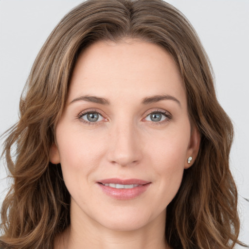 Joyful white young-adult female with long  brown hair and green eyes