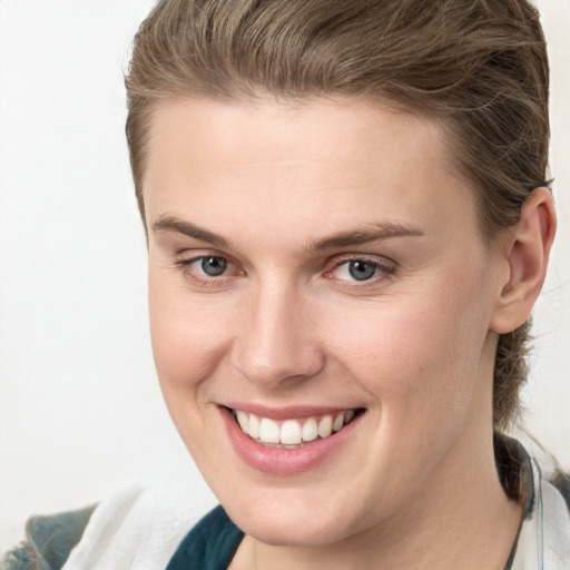 Joyful white young-adult female with medium  brown hair and grey eyes