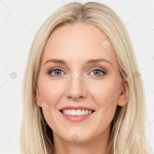 Joyful white young-adult female with long  brown hair and blue eyes