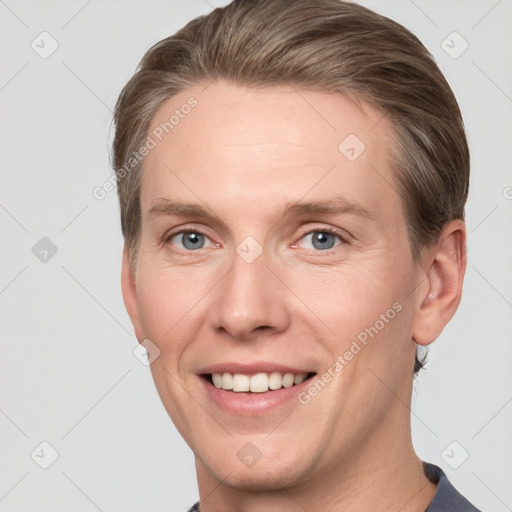 Joyful white adult male with short  brown hair and grey eyes