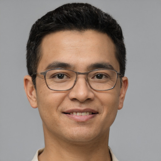 Joyful white young-adult male with short  black hair and brown eyes