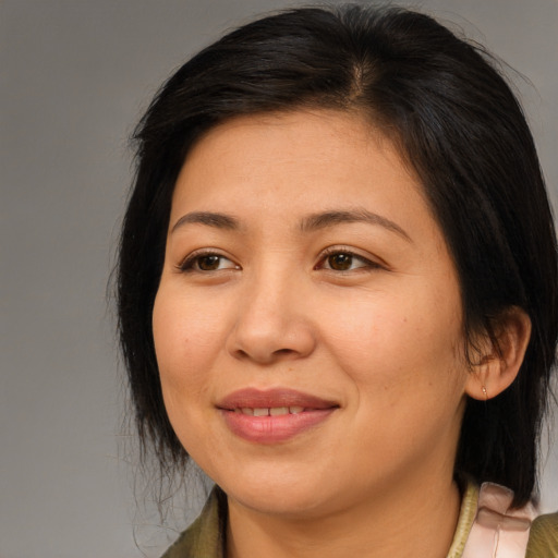 Joyful asian young-adult female with medium  brown hair and brown eyes