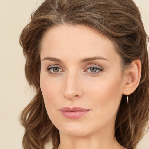 Joyful white young-adult female with long  brown hair and green eyes