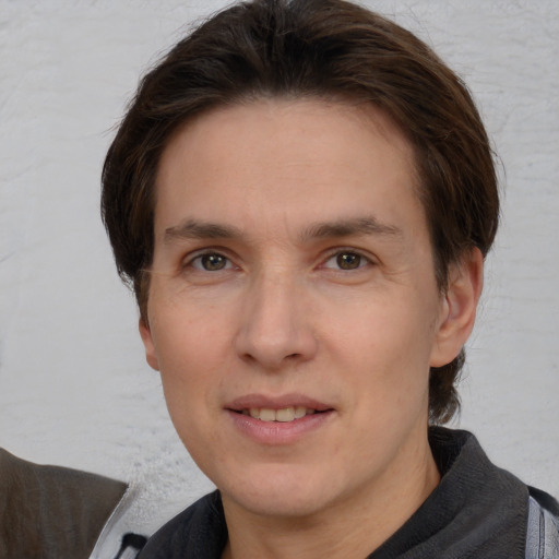 Joyful white adult male with medium  brown hair and brown eyes