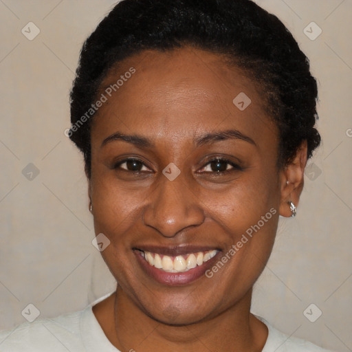 Joyful black young-adult female with short  black hair and brown eyes