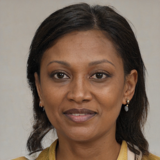 Joyful black adult female with medium  brown hair and brown eyes