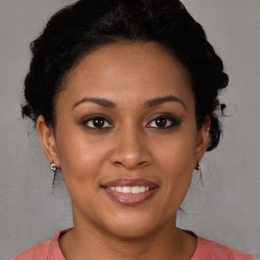Joyful latino young-adult female with short  brown hair and brown eyes