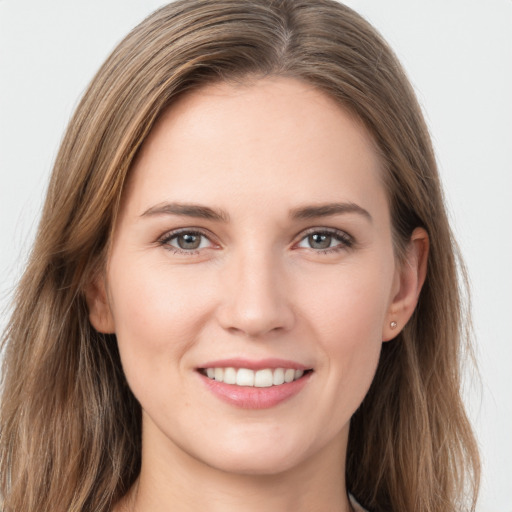 Joyful white young-adult female with long  brown hair and grey eyes