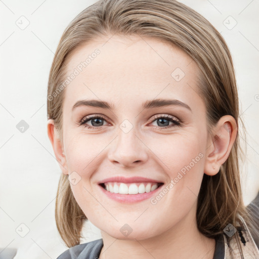 Joyful white young-adult female with medium  brown hair and blue eyes