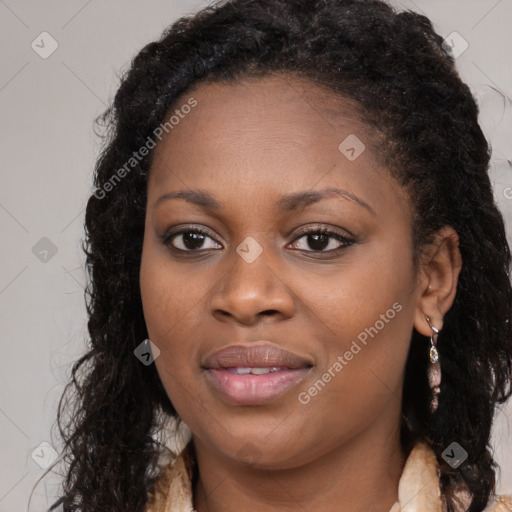 Joyful black young-adult female with long  brown hair and brown eyes