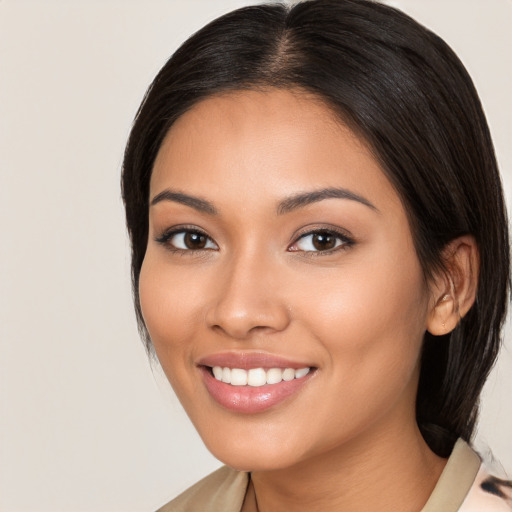 Joyful latino young-adult female with medium  brown hair and brown eyes