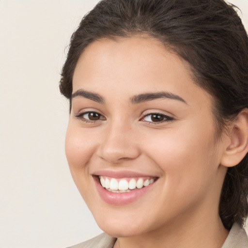 Joyful white young-adult female with medium  brown hair and brown eyes