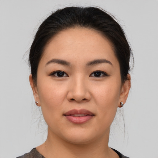 Joyful asian young-adult female with medium  brown hair and brown eyes
